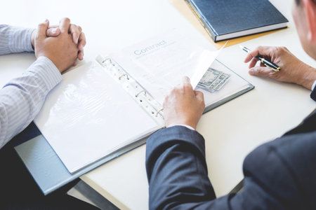 Businessman receive money in the envelope offered in file taking bribe and signing a contract - anti...