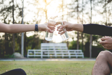 Early morning workout, Fitness couple stretching outdoors in park. Young man and woman exercising together in morning, Relationship healthy lifestyle fitness, sport conceptの写真素材