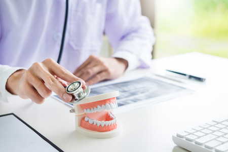 dentist doctor hands using Stethoscope to checkup tooth health, dental conceptの写真素材