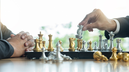 businessman playing chess game figures on wooden table for analysis new strategy plan, competition leader and teamwork concept for success.の写真素材