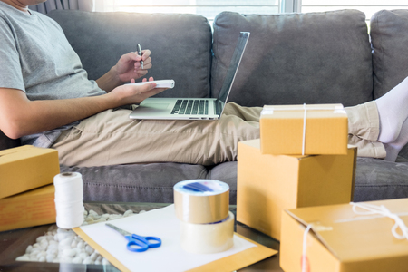 home and lifestyle concept,buying using credit card working with packaging startup entrepreneur small business e-commerce ownerの写真素材