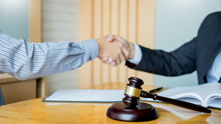 Law and Legal concept, Consultation between attorneys and clients customer shaking hands discussing contract agreement In Courtroomの写真素材