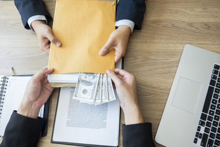 bribe and corruption concept, Corrupted businessman sealing the deal hand receiving venality bribe...