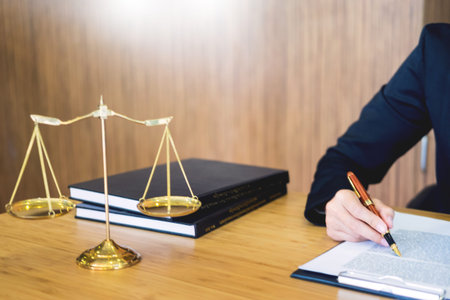 lawyer judge reading documents at desk in courtroom working on wooden desk background. gavel  golden...
