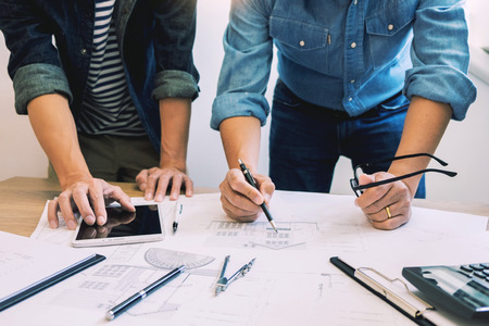 designers in the office are working Discussion Blueprint Architect on a new project Design Draw Teamwork on wooden deskの写真素材