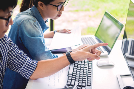 Asian team Outsource Developer Looking Screen Programming Code Working with Laptop Computer Softwareの写真素材