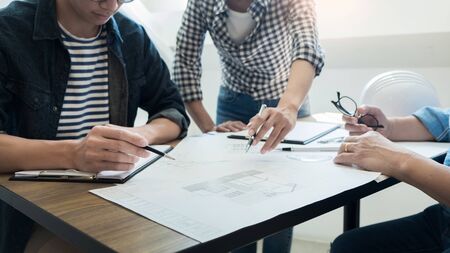 Engineer discussing meeting working on blueprint project architectural at construction siteの写真素材