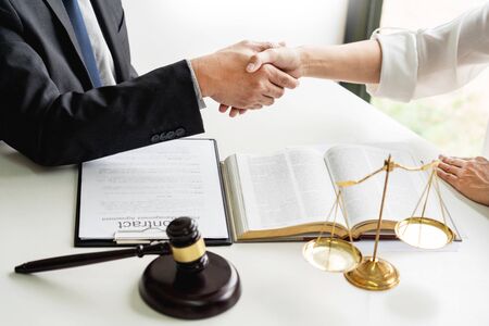 Handshake after cooperation between attorneys lawyer and clients discussing a contract agreement hope of victory over legal fighters, Concepts of law, adviceの写真素材