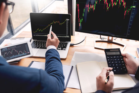 Business Team Investment Entrepreneur Trading discussing and analysis data the stock market charts...