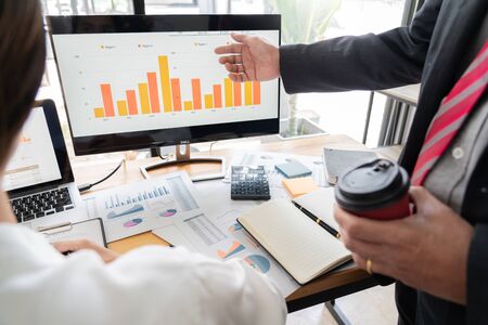 businessmen discussing project at meeting pointing explaining his idea charts and graph colleague at work having a meeting for project discussion.の写真素材