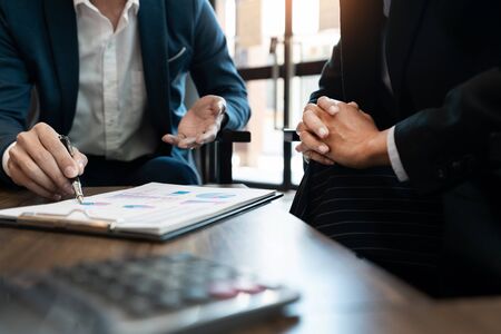 Business team cooperation coworking discussing about progress of business plan project advice and correcting mistakes during work in the Officeの写真素材