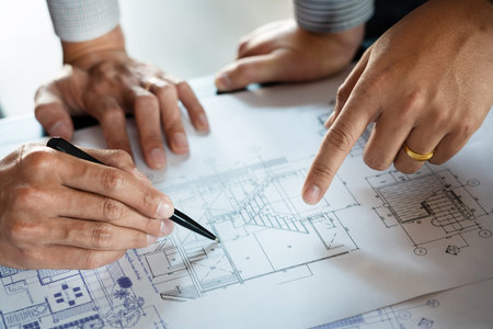Realestate concept, Two engineer and architect discussing blueprints data working and digital tablet...