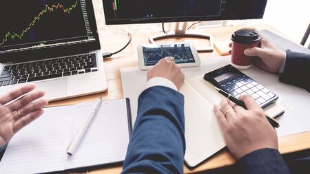 Business Team Investment Entrepreneur Trading discussing and analysis data the stock market charts and graphs negotiation and research budget, teamwork tradersの写真素材