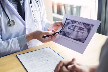 Dental hygienist demonstrating and showing a dummy jaw to chack-up or healing teeth  patientの写真素材