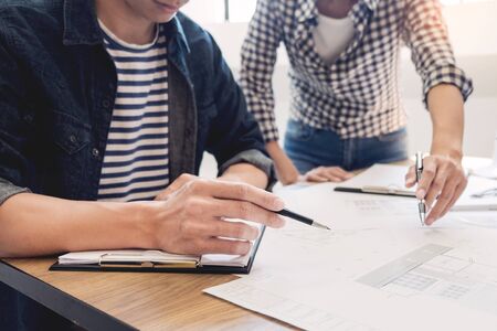 designers in the office are working Discussion Blueprint Architect on a new project Design Draw Teamwork on wooden deskの写真素材