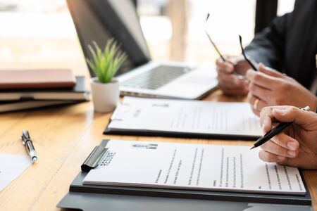 A Young Female Business women Applicant In Office Male Manager Interviewing holding resume and speaking to employer, job Interview employment and recruitment conceptの写真素材