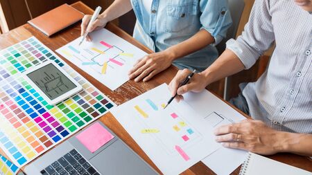 business technology concept, creative team designer choosing samples with UI/UX developing on sketch layout design mockup on smartphone application for mobile user interface design chartの写真素材