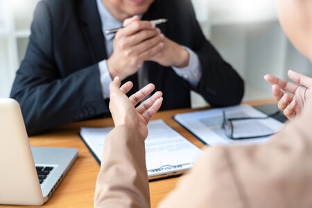 businessman candidate explaining about his profile and conducting a job to managers sitting in job Interview in modern office, consulting or employment conceptの写真素材