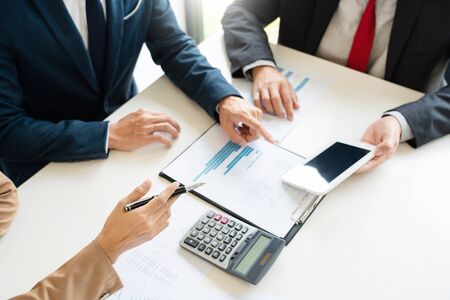Business People Talking Discussing with coworker planning analyzing financial document data charts and graphs in Meeting and  successful teamwork Conceptの写真素材
