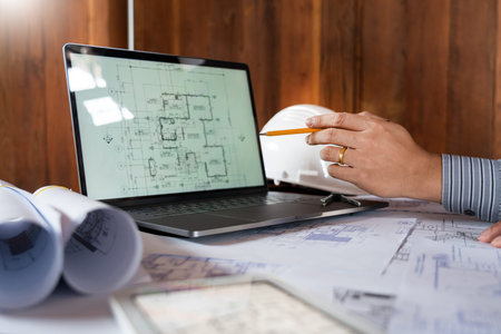 Real-estate concept, Two engineer and architect discussing blueprints data working and digital...