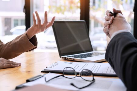businessman candidate explaining about his profile and conducting a job to managers sitting in job Interview in modern office, consulting or employment conceptの写真素材