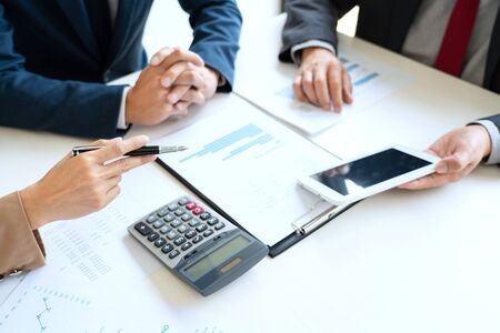 Business People Talking Discussing with coworker planning analyzing financial document data charts and graphs in Meeting and  successful teamwork Conceptの写真素材