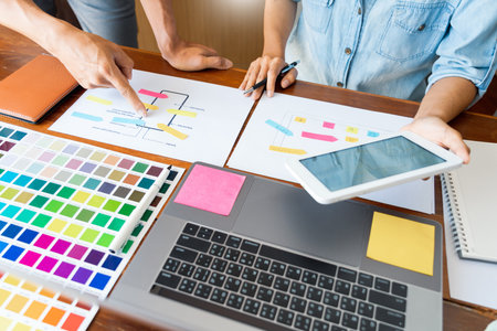 business technology concept, creative team designer choosing samples with UI/UX developing on sketch...