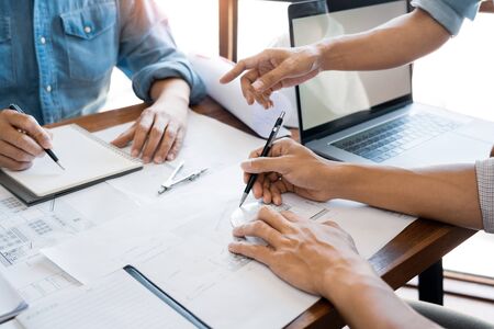 Engineer architect design team colleagues working office discussing meeting discussion construction project conceptの写真素材