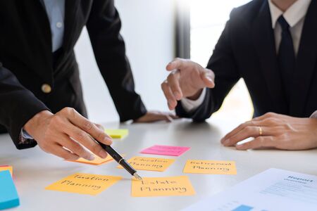 wealth management concept, business man and team analyzing financial statement for planning financial customer case in officeの写真素材