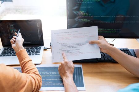Asian team Outsource Developer Looking Screen Programming Code Working with Laptop Computer Softwareの写真素材
