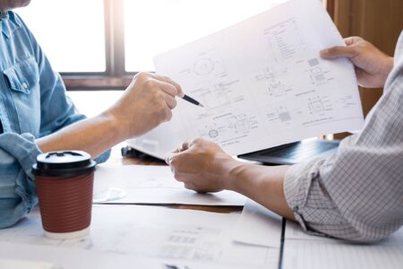 Architects engineer discussing at the table with blueprint, teamwork and work flow construction conceptの写真素材