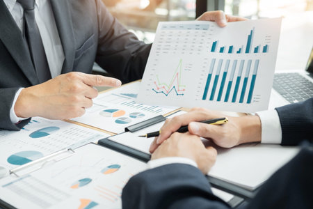 Business People Talking Discussing with coworker planning analyzing financial document data charts...