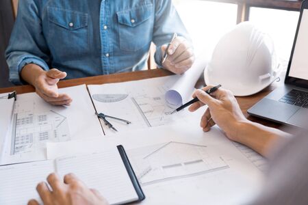 Engineer architect design team colleagues working office discussing meeting discussion construction project conceptの写真素材