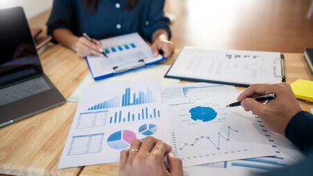 Business People Talking Discussing with coworker planning analyzing financial document data charts and graphs in Meeting and successful teamwork Conceptの写真素材