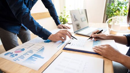 Business People Talking Discussing with coworker planning analyzing financial document data charts and graphs in Meeting and successful teamwork Conceptの写真素材