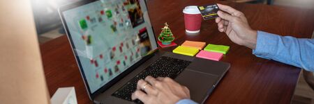 Online shopping credit card data security concept, Hands holding credit card and using smart phone or laptop to shopping or making online paymentの写真素材