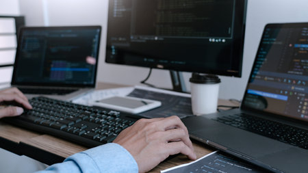 Programmer Typing Code on desktop computer, Developing programming and coding technologies concept