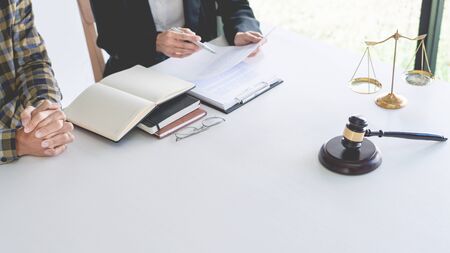 lawyer having meeting and consoling solution to his clients provide legal advice and trust commitment strain serious for problem, justice and attorney conceptの写真素材