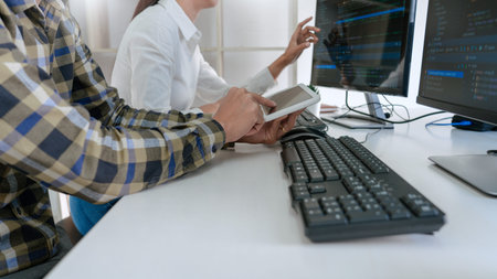 Pensive programmer working on desktop pc programming code technologies or website design at office...