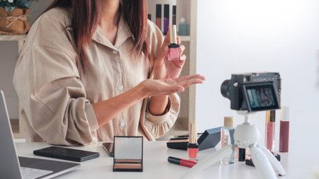Makeup Beauty fashion blogger recording video presenting cosmetics at home influencer on social...