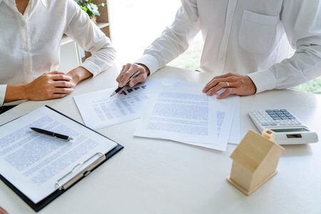 employee meeting broker estate agent for contact to apartment and signing document agreement