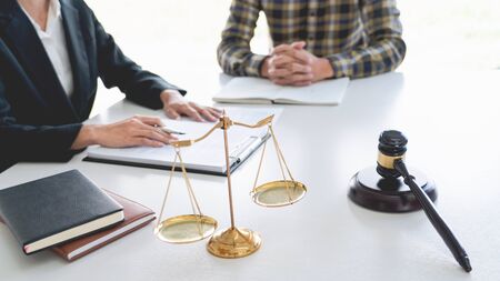 business people and lawyers discussing contract papers sitting at the table. Concepts of law  advice  legal services.の写真素材
