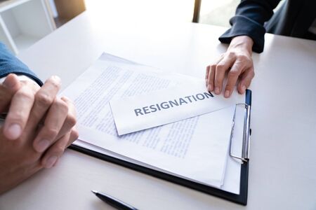 Businessman sending resignation letter to the executive employer boss on desk in order to resign dismiss contract, job placement and vacancies conceptの写真素材