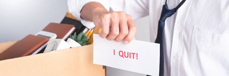 Businessman holding with I quit words card letter, resign employee Change of job conceptの写真素材