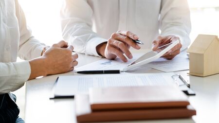 Real Estate Agent broker or House developer showing contract for buying house agreement to consultant employeeの写真素材