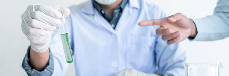 Scientist wear lab coat and protective wear are working with research or doing investigations with...
