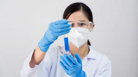 Coronavirus vaccine COVID-19 bottle for injection in hand of doctor or Technician scientist in a...