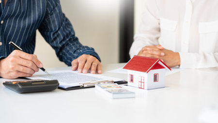 Real estate agents explain the document for customers who come to contact to buy a house, buy or...
