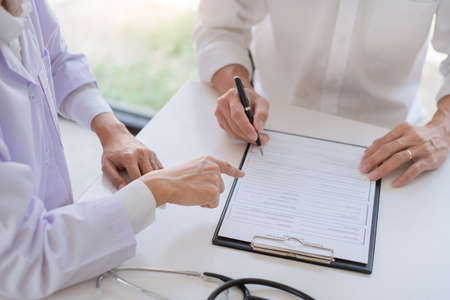 doctor giving consulting and diagnostic to patient and explaining medical informations prevention diseases and diagnosis, in medical clinic or hospital healthcare service centerの写真素材