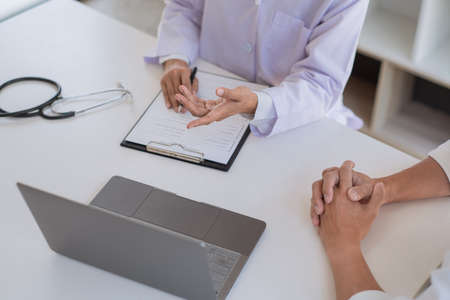 scientists researching in laboratory in white lab coat, gloves analysing, looking at test tubes sample, biotechnology concept.の写真素材